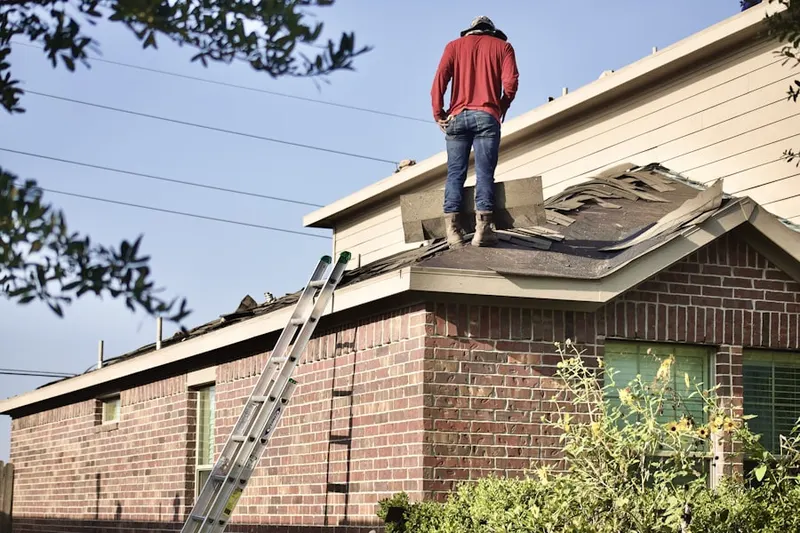 Professional roofer working on a residential roof in West Torrington